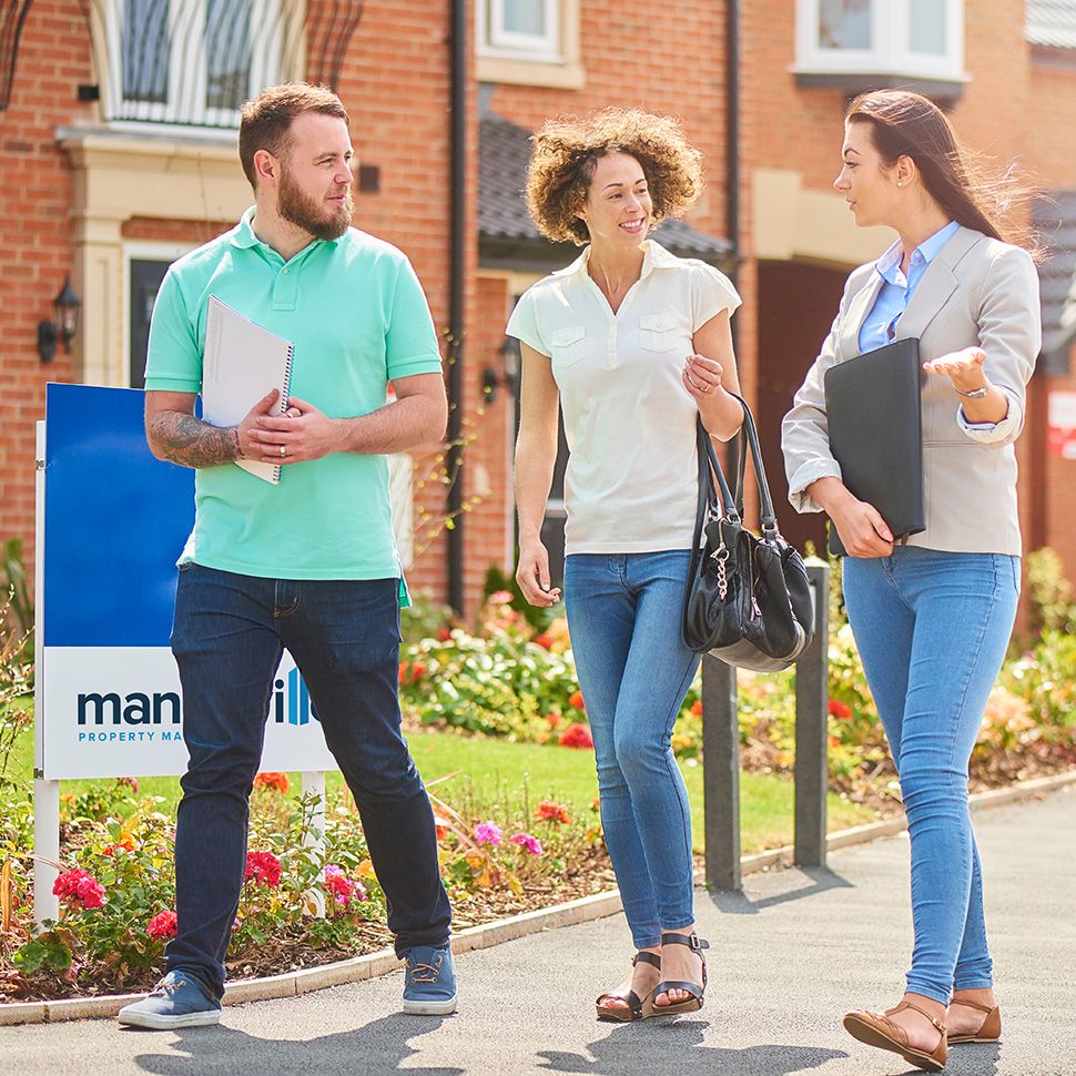 Mandeville employee on a site visit discussing with a couple of residents